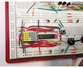 The algorithm in this microcontroller design this design drives an LED matrix and provides digital-voltage-readout and bar-like dot displays, showing dots for a graphical output if the input value is changing, and switching automatically to displaying a numeric value when the input voltage is stable.
