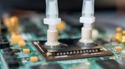 The researchers placed a silicon layer over microfluidic passages etched into the FPGA and ports were attached for water tubes, which pumped deionized water over the chip. (Image courtesy of Rob Felt, Georgia Tech). The researchers placed a silicon layer over microfluidic passages etched into the FPGA and ports were attached for water tubes, which pumped deionized water over the chip. (Image courtesy of Rob Felt, Georgia Tech).