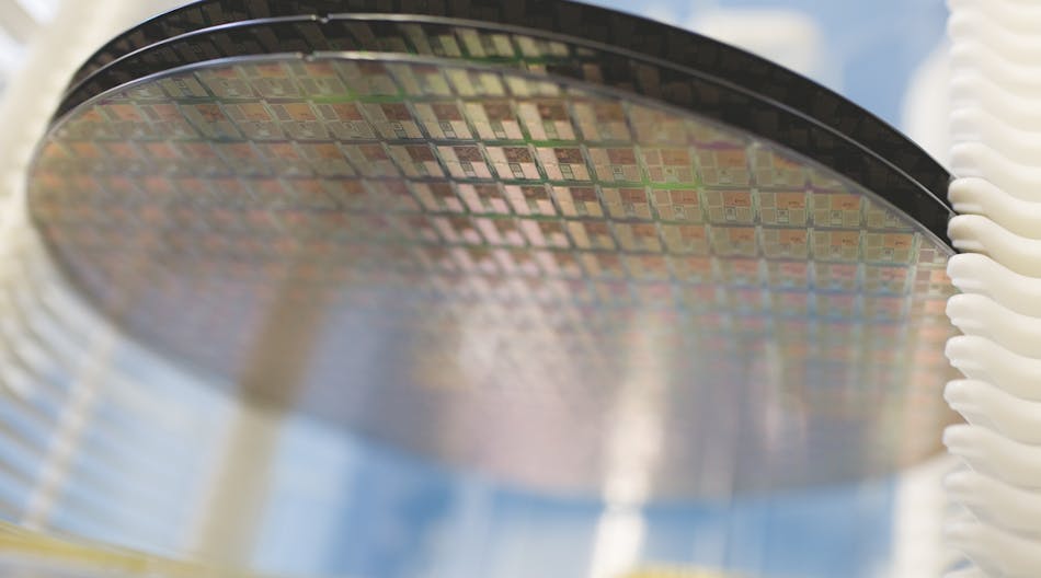 Silicon wafer made by NXP Semiconductors. The Dutch chipmaker, which supplies parts to automakers and device makers like Apple, recently said that it was selling its standard product business for $2.75 billion. (Image courtesy of NXP).
