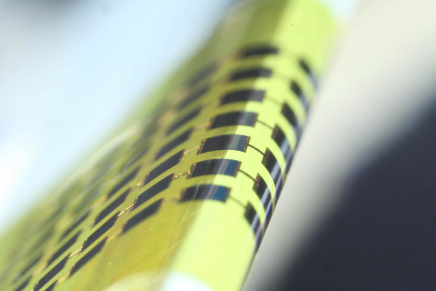 The prototype solar cell can be wrapped around small objects like the edge of this glass laboratory slide Image courtesy of Juho Kim Applied Physics Letters