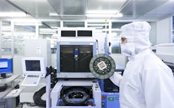 An Infineon Technologies engineer holds a 200 millimeter wafer in a semiconductor cleanroom in Dresden Germany Image courtesy of Infineon An Infineon Technologies engineer holds a 200 millimeter wafer in a semiconductor cleanroom in Dresden Germany Image courtesy of Infineon