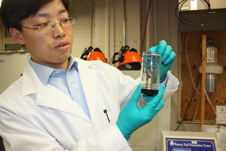 Guangsheng Zhang a research associate at Penn State holds a punctured lithiumion battery With growing safety concerns researchers are developing batteries with thermal sensors that act like failsafes Image courtesy of Penn State