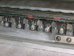 5. This electric-car motor controller prototype uses the busbars as heat sinks. This one was damaged by overcurrent on the FET source connections, which have melted. (Courtesy of Otmar Ebenhoech) 5. This electric-car motor controller prototype uses the busbars as heat sinks. This one was damaged by overcurrent on the FET source connections, which have melted. (Courtesy of Otmar Ebenhoech)