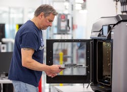 Dave Jacek, 3D printing technician, unloads 3D-printed medical face shield parts at Ford&rsquo;s Advanced Manufacturing Center. (Cred: Ford Motor Company)