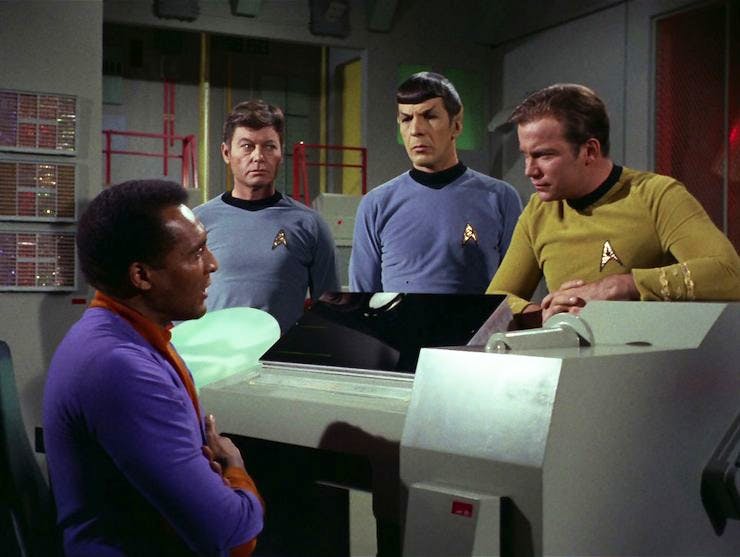 3. Doctor Richard Daystrom (left) talks to Dr. McCoy, Mr. Spock, and Captain Kirk about his M-5 computer (center) that has been programmed with Dr. Daystrom&rsquo;s engrams.