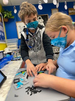 1. FIRST LEGO League participants assembling their project. 1. FIRST LEGO League participants assembling their project.