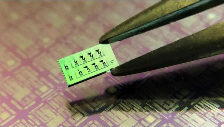 2. The fabricated silicon-on-insulator device measures approximately 3 &times; 6 mm and has eight detectors. The fine black engravings on the device&rsquo;s surface are the photonics circuits interconnecting the detectors.