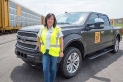 Linda Zhang, chief engineer of the Ford F-150, shows the capability of a prototype all-electric F-150 by towing 10 double-decker rail cars and 42 2019-model year F-150s, weighing more than a million pounds.