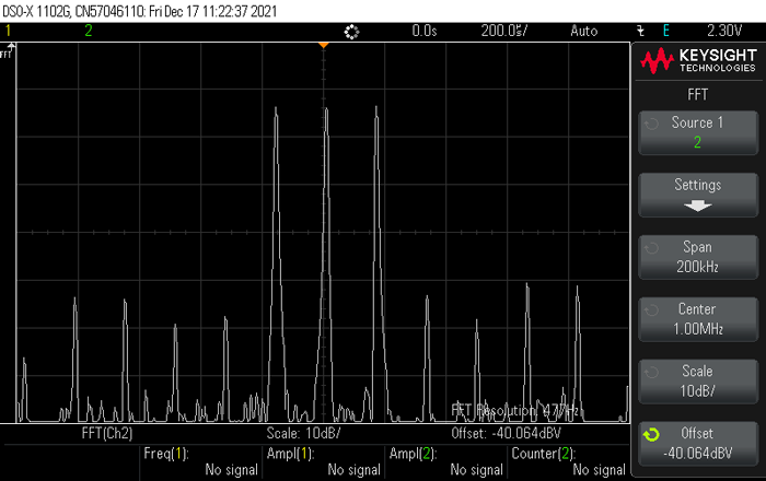 6. This oscilloscope screen capture shows a triple tone test in the frequency domain.