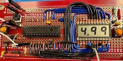 3. PCB showing a voltage measurement of 4.99 V.