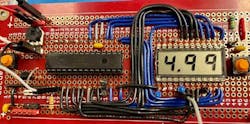 3. PCB showing a voltage measurement of 4.99 V. 3. PCB showing a voltage measurement of 4.99 V.