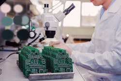 2. Manual vision inspection uses microscopes to examine printed circuit boards.