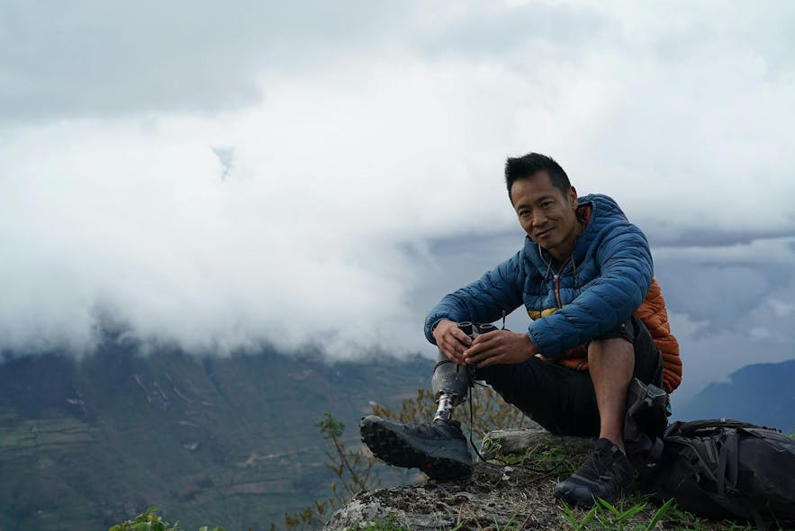 Albert Lin sitting on the edge of a cliff during his quest to find the lost city of the Chachapoyas in Peru.