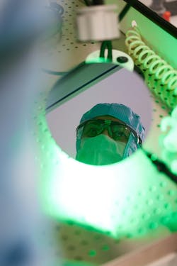 2. An IQE technician's face is reflected in a third-generation semiconductor wafer. 2. An IQE technician's face is reflected in a third-generation semiconductor wafer.