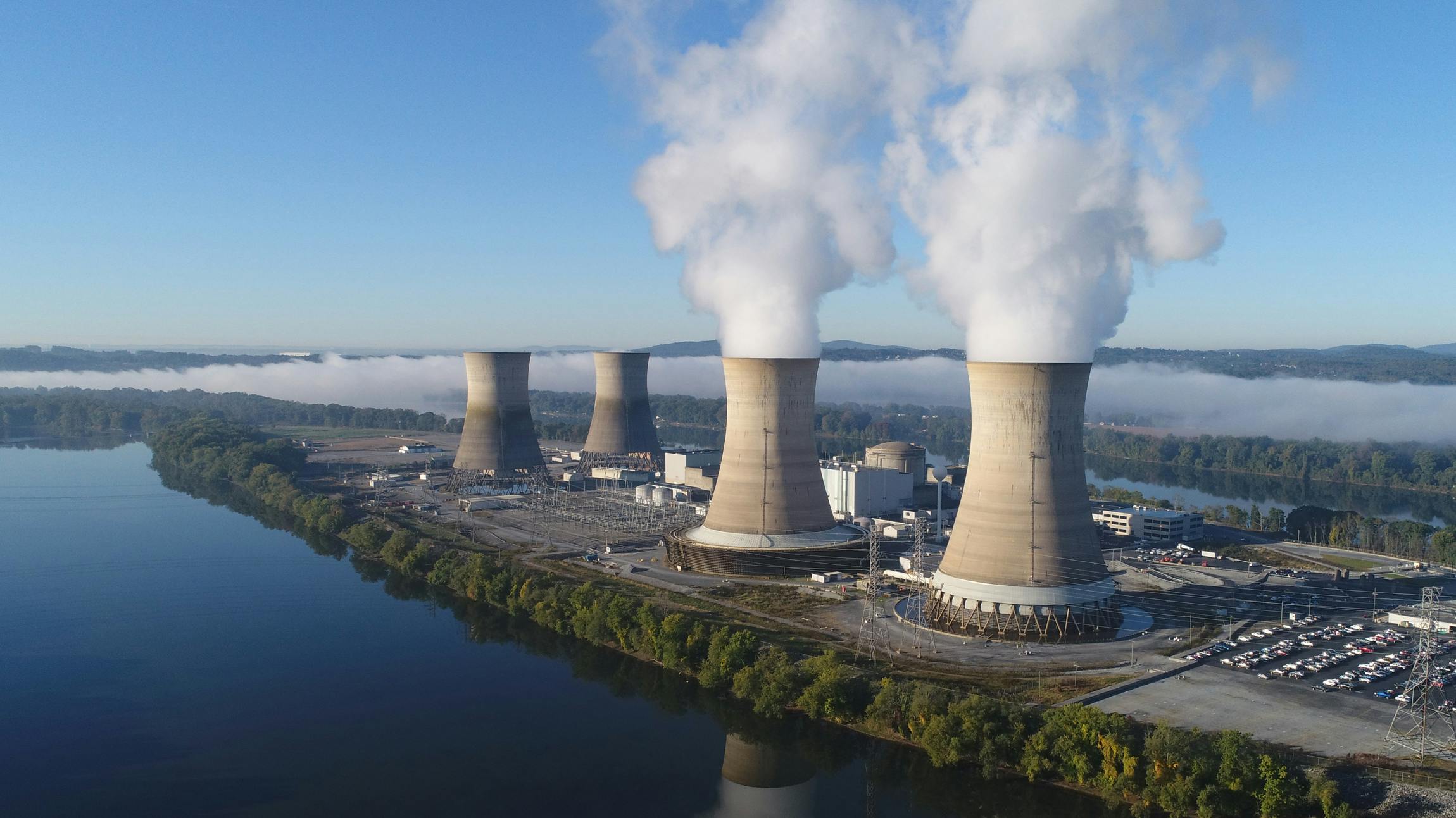 1. The working cooling towers of Exelon Generation Unit 1 in the foreground at Three Mile Island are emitting water vapor. The dormant cooling towers are from Unit 2, which was permanently damaged in the 1979 accident.