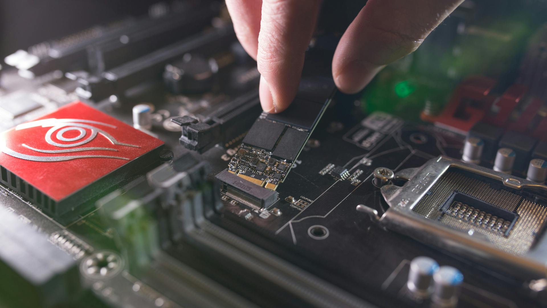 Focus at SSD slot, type M.2 with support for NVMe, on computer motherboard.