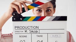 Portrait Of Female Videographer Holding Clapper Board On Video Film Production In White Studio Portrait Of Female Videographer Holding Clapper Board On Video Film Production In White Studio