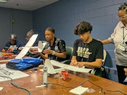 4. High school students attending a summer aviation camp learn about aerodynamics, technology, and teamwork while building model gliders together. 4. High school students attending a summer aviation camp learn about aerodynamics, technology, and teamwork while building model gliders together.