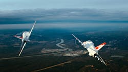 Two T-45C Goshawk jets separate to begin a dogfight Two T-45C Goshawk jets separate to begin a dogfight