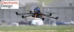 5. MTech's coned and hooped hexacopter takes flight with the DARPA Olympic Standard Barbell weight plates affixed. The straps kept changing — these look like ones from Harbor Freight as a bodge to give the machine stability over the original wire (likely Dyneema) suspension of the payload.