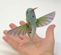 Figure 1. Aeroenvironment's Nano Hummingbird nano air vehicle (NAV), as developed for DARPA. Note the landing gear and camera.