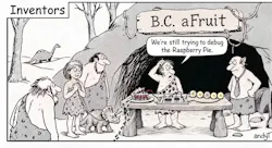 A black-and-white cartoon titled “Inventors.” Outside a prehistoric cave, several Stone Age people and a small triceratops gather around a crude worktable. A sign above the cave reads “B.C. aFruit.” On the table, a slice of raspberry pie with ants crawling on it sits beside a primitive electronic circuit connected by wires to a row of lemon-slice batteries. One caveman scratches his head and says, “We’re still trying to debug the Raspberry Pie.” A dinosaur stands in the background, while a modern-looking man in a shirt and tie watches from the cave entrance.